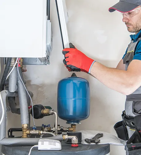 Technician repairing a heating unit, highlighting quality service and expertise.