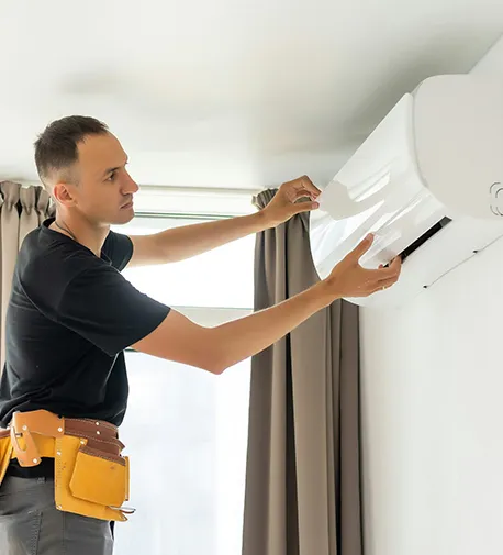 Technician installing an air conditioning unit indoors, emphasizing why to choose us for AC repair services in Dunnellon, FL.