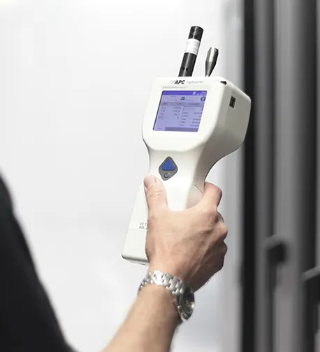 Image of a person holding an air quality monitoring device, highlighting reliable air quality services.