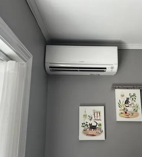 Interior view of a room with a modern wall-mounted AC unit, highlighting the benefits of professional AC services.