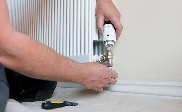 Technician inspecting a heating system, offering dependable service in The Villages, FL.