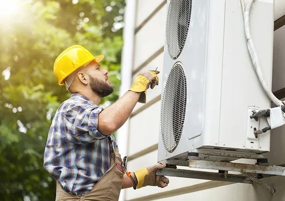 Expert installing an air conditioning unit in Gainesville, FL, showcasing simple and effective installation.