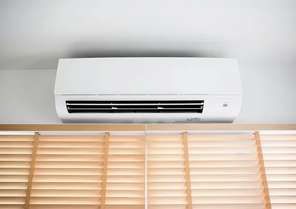 Technician inspecting a split system AC unit in The Villages, Florida, for effective maintenance.