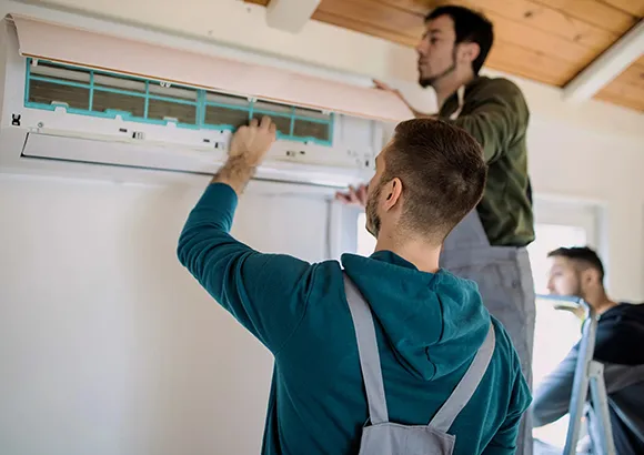 Technician installing an air conditioning unit at AC Installation Services in Silver Springs Shores, FL, showcasing expert HVAC installation.