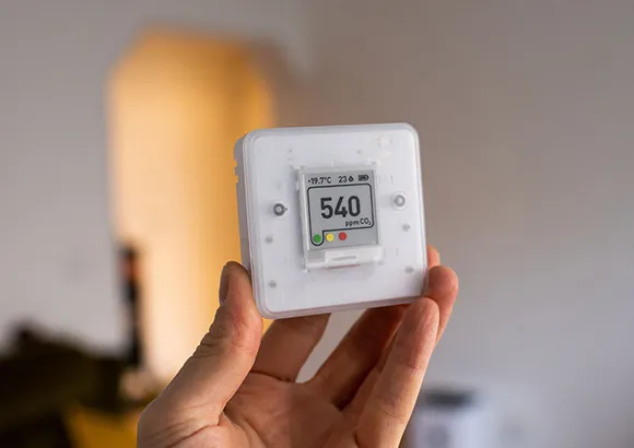 Expert performing air quality testing with a handheld device in Gainesville, FL.
