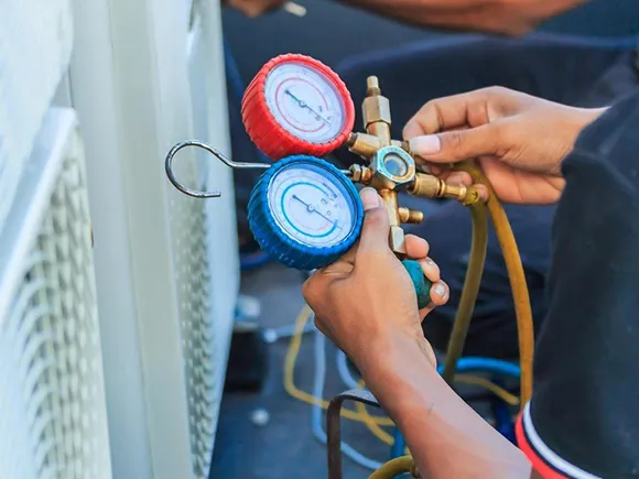 Technician recharging an AC unit with Freon in Silver Springs.
