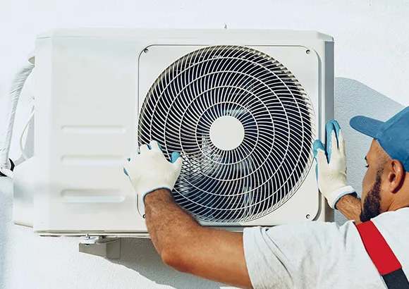 Skilled technician repairing a ductless AC machine in Belleview, FL, with tools and equipment for professional service.