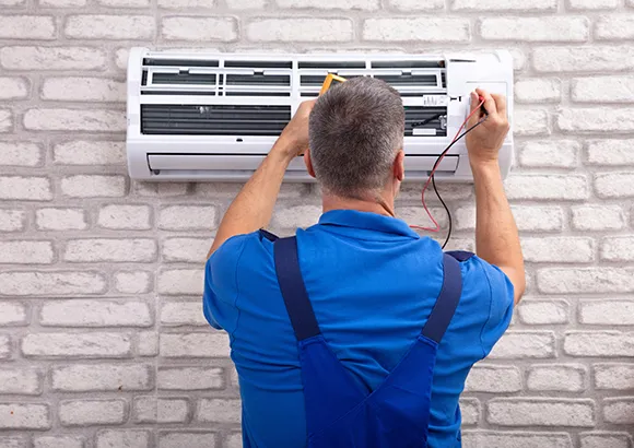 Technician performing air conditioning maintenance in Ocala, FL, ensuring optimal system performance and efficiency.